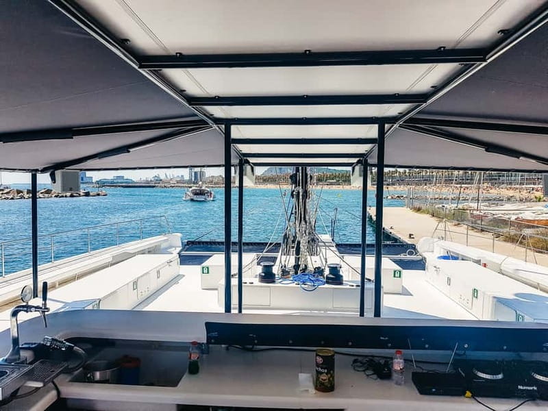 Barcelona: Catamaran Party Cruise with BBQ Meal - Drinks, dancing, and the return to Port Olímpic