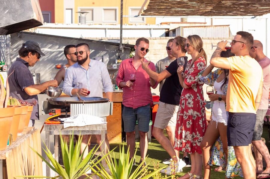 Barcelona: Rooftop Paella Cooking Class with Sangria - Sitting down to eat what you made