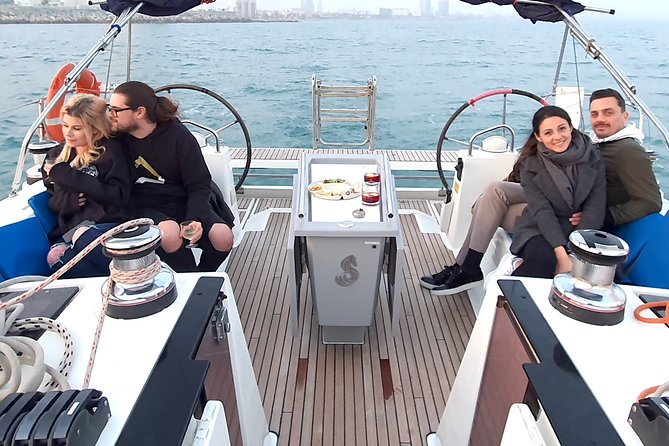Barcelona Unforgettable Sailing Cruise with Open Bar and Snacks - Raising the sails beside the Olympic harbor